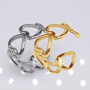 Detailed shot of open adjustable gold and silver rings with hollow heart design