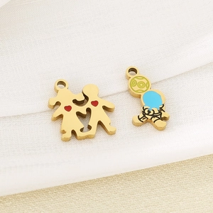 Close-up of golden stainless steel boy girl and astronaut charms with colorful heart detail