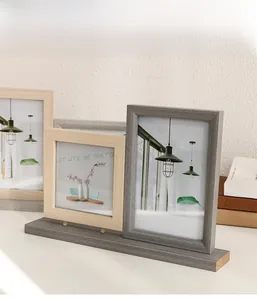 Macro shot of 4x6 inch minimalist gray and light wood grain frames in a wooden slot base