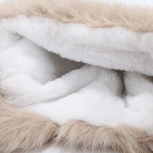 Detailed macro view of the soft faux fur lining and plush cream fleece of the warm earflap hat