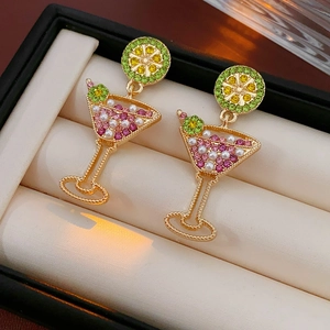 Detail view of gold cocktail glass earrings with colorful rhinestones and pearls