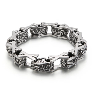 Vintage silver steel men's bracelet with X-shaped links and floral carvings on grey metal