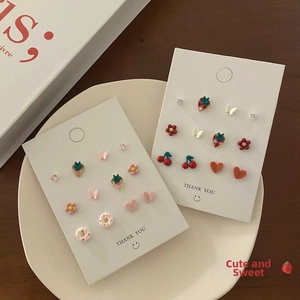 Detailed view of s925 silver star pearl tassel earrings set with strawberry and heart shapes