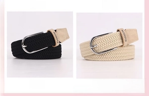 Detailed view of elastic woven belt with polished metal buckle and brown leather tips