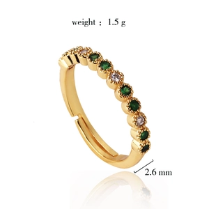 Adjustable 18K gold plated lace ring featuring inlaid green and white cubic zirconia