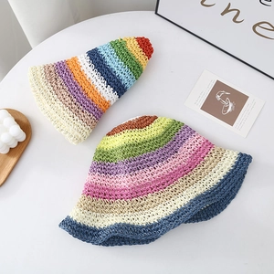 Detail of colorful rainbow crochet straw hat showing foldable design and woven texture