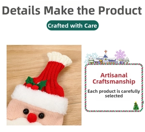 Detail of knitted Santa Claus wine bottle cover with red berries and green felt leaves