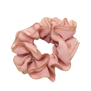 Pink chiffon hair scrunchie with golden stitched edges on a clean white background
