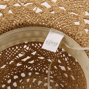 Detail of handmade straw cowboy hat featuring adjustable sweatband and 100% paper fiber
