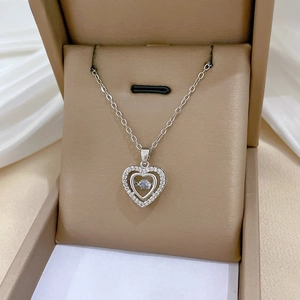 Detail view of silver heart pendant necklace with shimmering zircons in a jewelry box