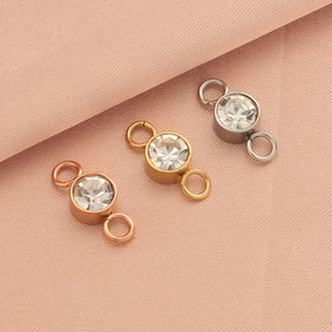 Detailed view of dual-loop birthstone connectors in rose gold, gold, and silver finishes