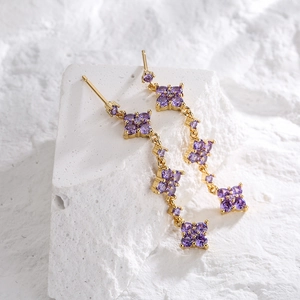 18K gold-plated tassel earrings featuring purple clover motifs on textured stone