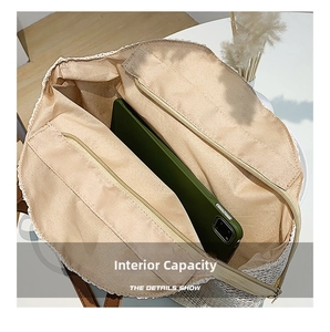 Top view of large capacity straw bag interior with zipper pocket and tablet reference