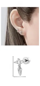 Detail shot of silver cartilage piercing featuring a zirconia star and cone pendant