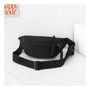 Close-up of black canvas chest bag with adjustable strap and plastic buckle for kids