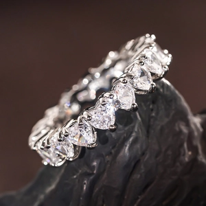 Macro shot of heart-shaped cut cubic zirconia eternity ring in classic claw setting