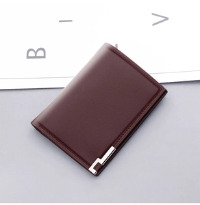 Macro shot of men's short leather wallet with modern L-shaped metal corner trim