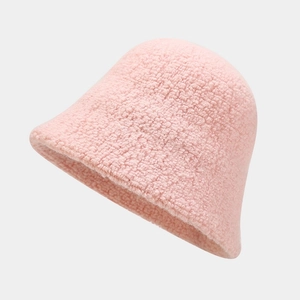 Close-up of pink faux shearling bucket hat texture showing plush fleece grain detail