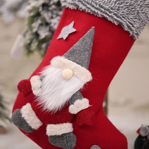 Christmas stocking with gnome plush doll and gray star appliqué for festive decoration