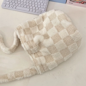 Close-up of fluffy checkerboard plush bucket bag showing soft texture and wide strap