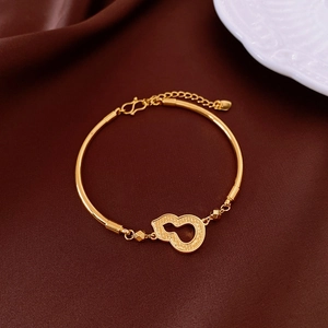 Dettaglio del bracciale a zucca placcato oro 18k con gancio a S su seta marrone scuro