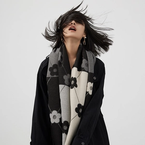 Fashionable cashmere-feel winter scarf with floral and geometric patterns on a female model