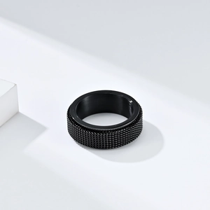 Minimalist black stainless steel mesh rotating ring with industrial knurled texture finish