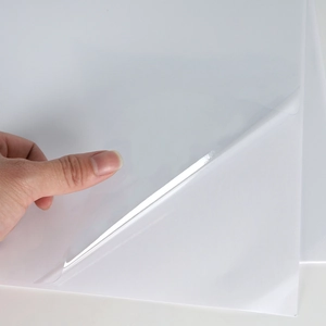 Detail of transparent PVC anti-scratch protective film showing high flexibility and adhesive backing