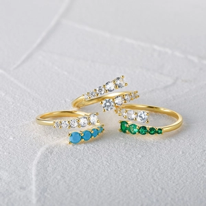 Detailed macro view of S925 sterling silver open rings with gold plating and colorful zircons