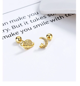 Detailed close-up of gold planet and moon screw-back studs with sparkling zircon stones
