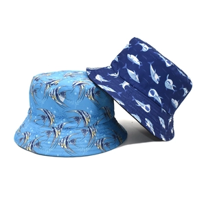Close-up of dual-sided fisherman hat featuring tropical fish and shark ocean patterns