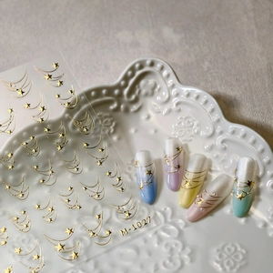 Golden star nail art stickers M-1027 with celestial patterns on colorful manicure