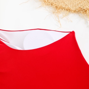 Detailed macro view showing the soft white honeycomb lining and padded cups of a red swimsuit