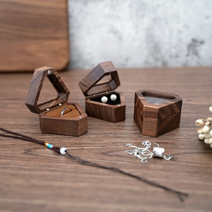 Macro detail of hexagonal walnut wood jewelry boxes for rings and earrings storage