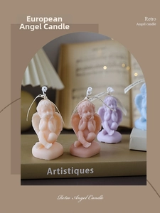 Close-up of vintage cherub scented candles in Morandi tones on retro books