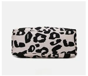 Flat view of waterproof oxford fabric travel bag base with black cow pattern print