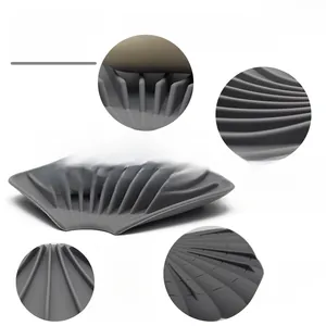 Macro detail of grey silicone soap dish featuring drainage ridges and non-slip surface
