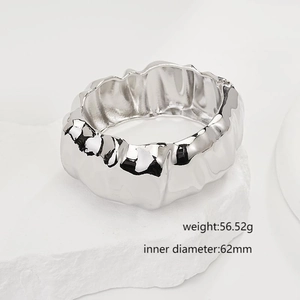 Detailed view of silver irregular textured cuff bracelet with size and weight specs