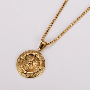 Macro detail of golden stainless steel lion head pendant with Greek fret pattern border