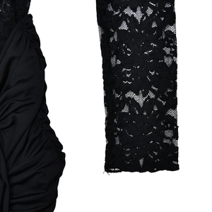 Close-up of elegant black lace floral sleeve and ruched fabric detail on dress