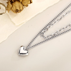 Detail of silver double-layered titanium steel necklace with a polished heart pendant