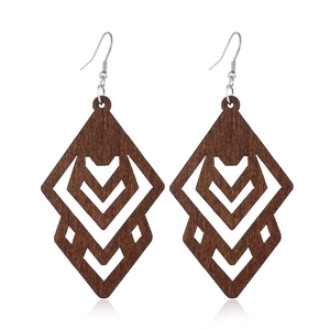 Detailed close-up of dark brown hollow geometric wooden earrings on a white background