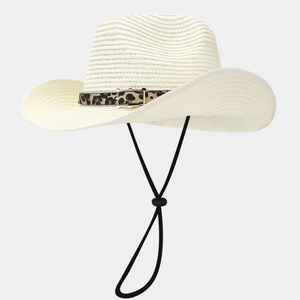 Detail of summer straw panama hat featuring leopard print belt buckle and windproof cord