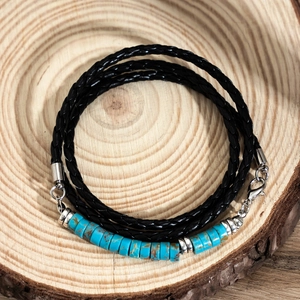 Men's multi-layer braided leather bracelet with blue turquoise beads on natural wood