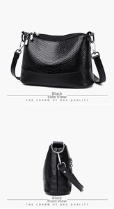 Close-up of black PU leather handbag with snake pattern texture and silver hardware