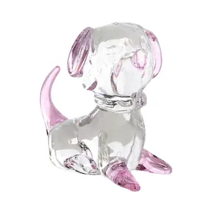 Close-up of a handmade glass dog figurine with pink accents and crystal-clear finish