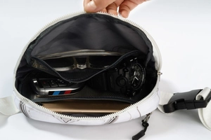 Internal view of a leopard print fanny pack showing storage space for phone and keys