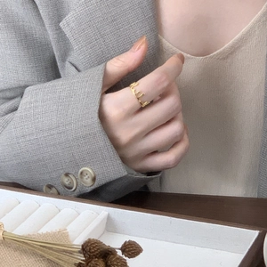 Artistic golden lava drop ring with modern irregular wavy texture on model finger
