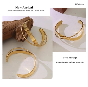 Detailed view of crossover 18K gold plated minimalist stainless steel open cuff bracelet