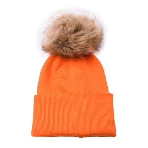 Detailed texture of orange ribbed knit baby hat with a fluffy dark brown faux fur pom pom